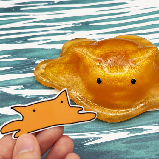 Cat-shaped resin blob on a striped background