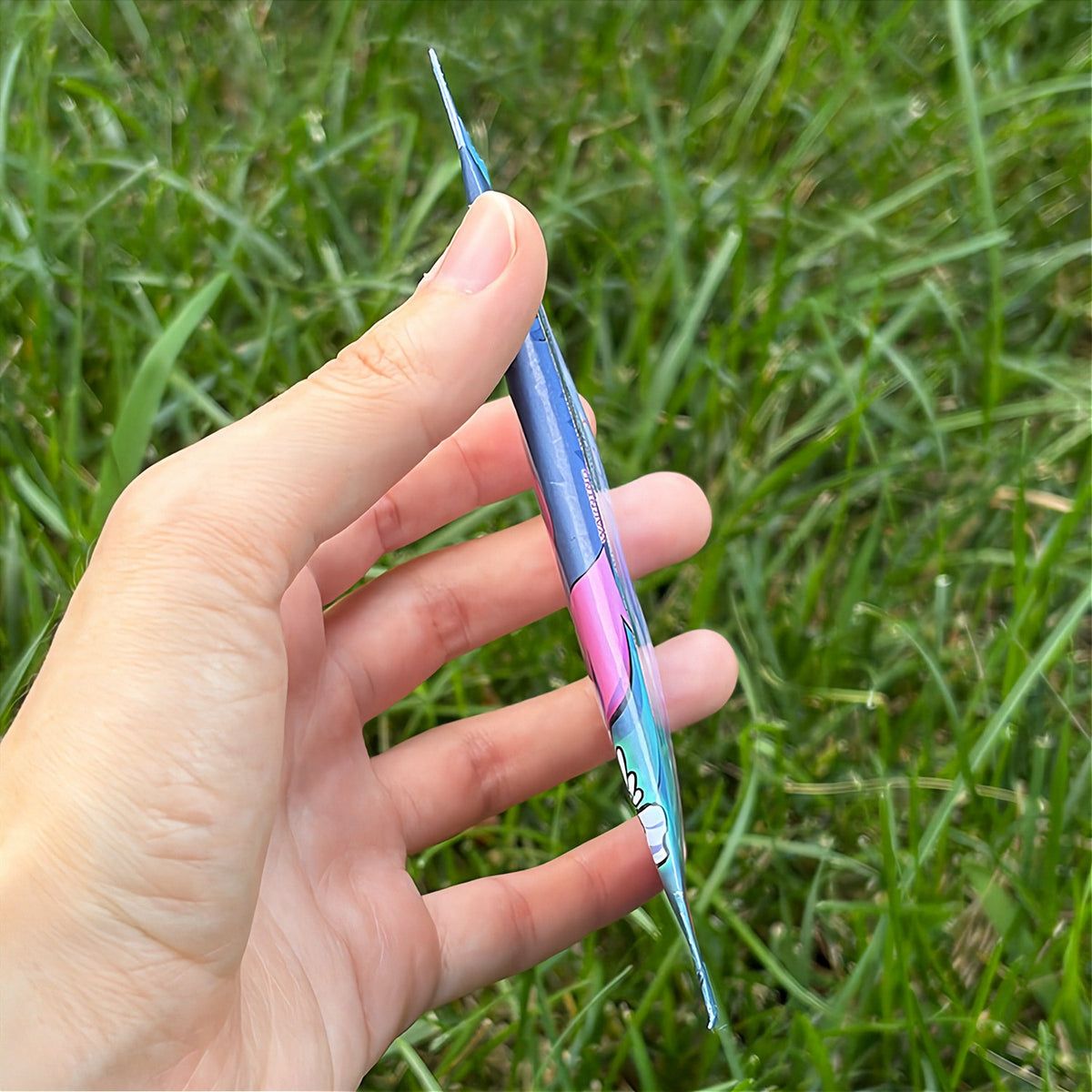 A hand holds a cartoon sticker next to a printed card pack titled "CopyCards Faithful Flock" on grass outdoors.