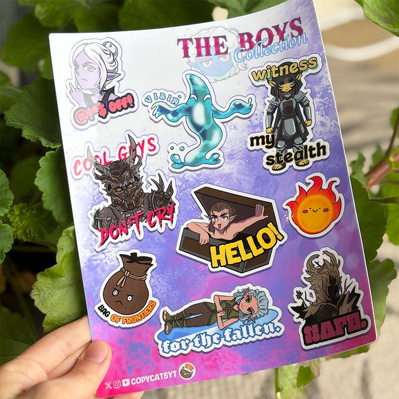 Sheet of 'The Boys' themed stickers held in front of green leaves