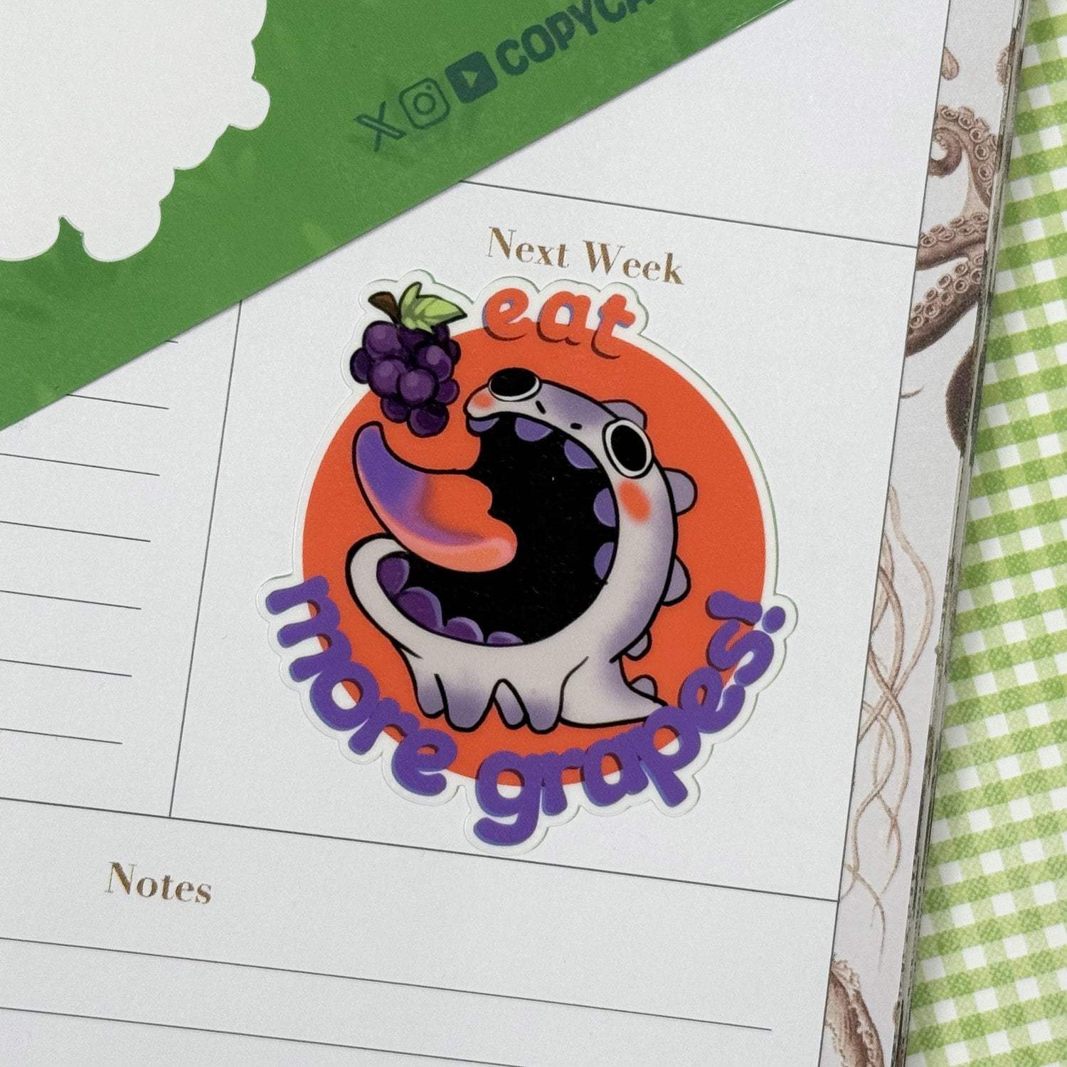 dino buddy sticker on a notebook