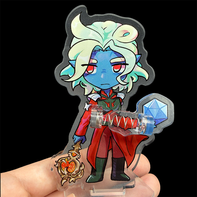 Colorful character figurine with a dice and staff on a reflective surface