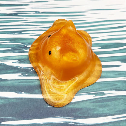Cat-shaped resin blob on a striped background