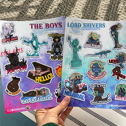 Two sticker sheets from 'The Boys' and 'Lord Shivers' collections held by a hand.