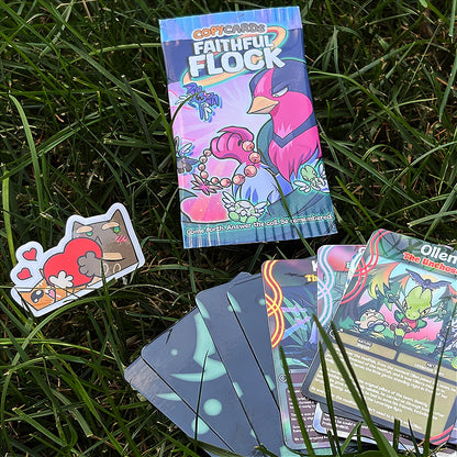 A hand holds a cartoon sticker next to a printed card pack titled "CopyCards Faithful Flock" on grass outdoors.