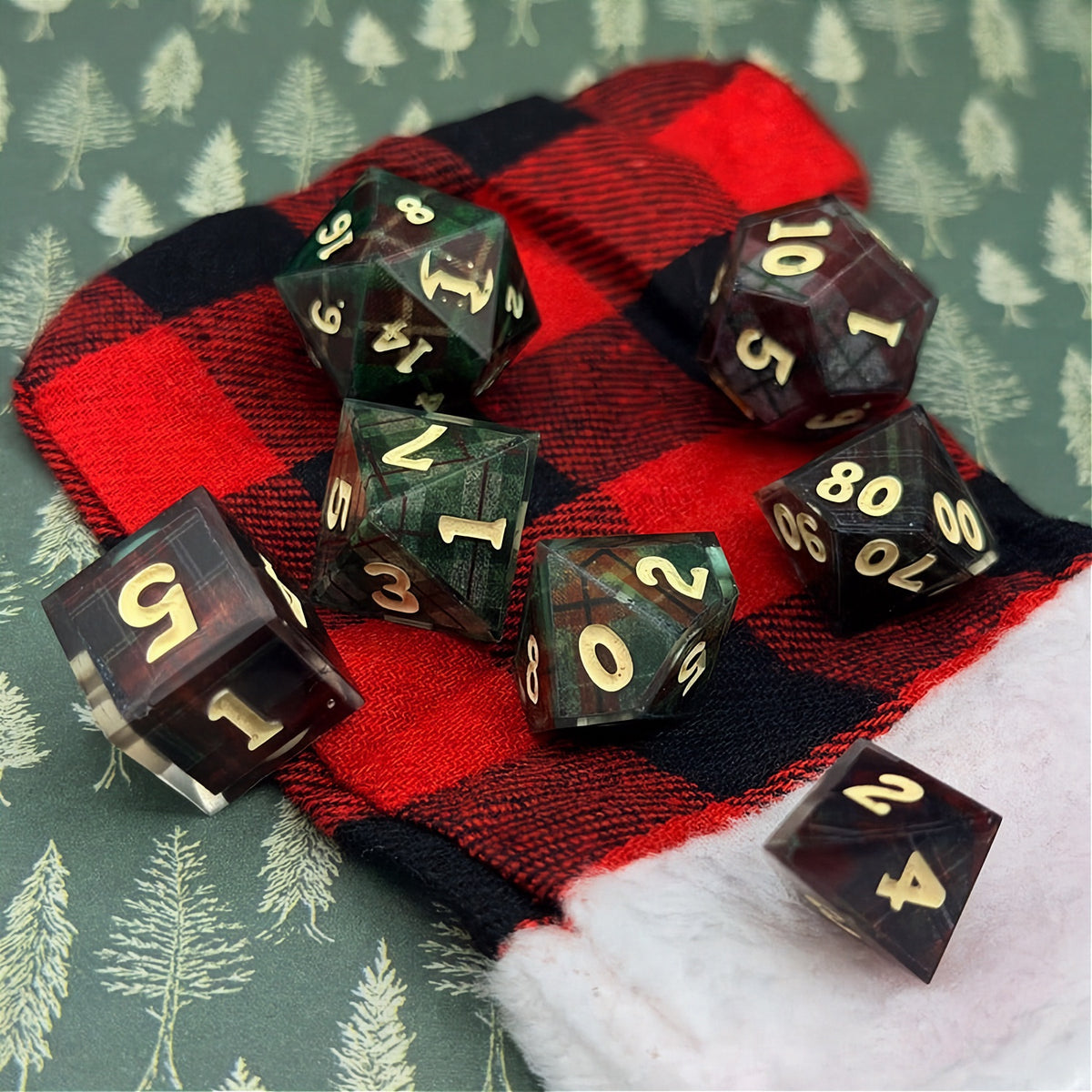 Set of polyhedral dice with red and black plaid fabric and white fur stocking background