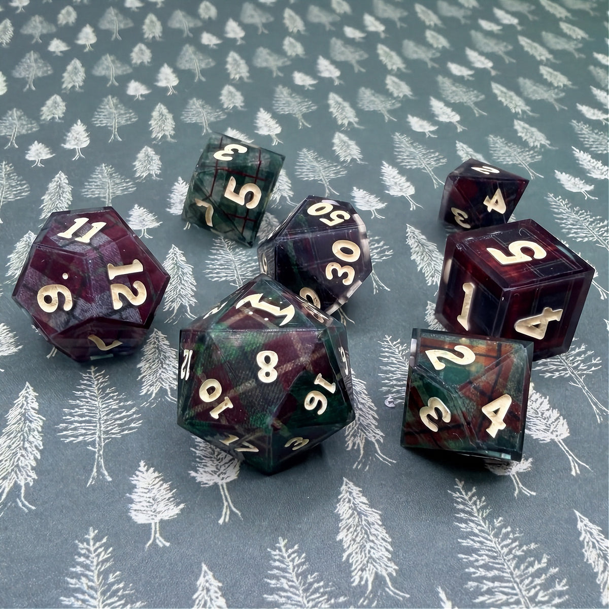 Set of polyhedral dice with red and black plaid fabric and white fur stocking background