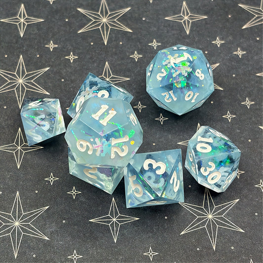 Set of icy blue dice with star patterns on a dark background
