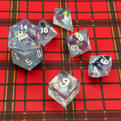 Set of icy blue dice with star patterns on a dark background