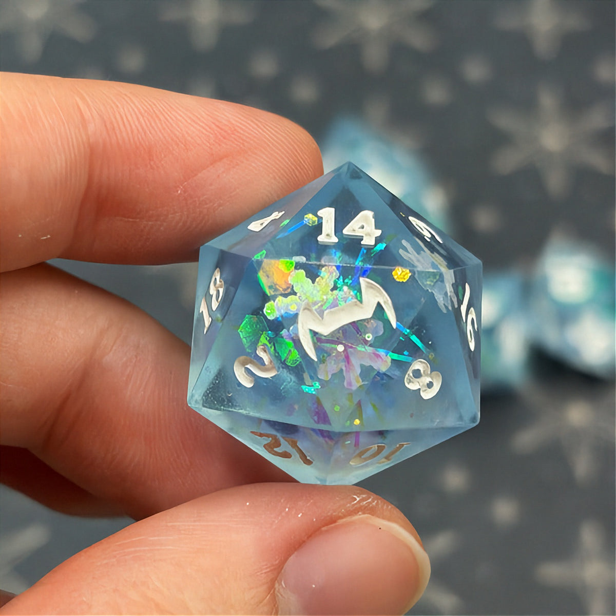 Set of icy blue dice with star patterns on a dark background