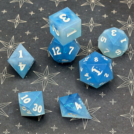 Set of icy blue dice with star patterns on a dark background