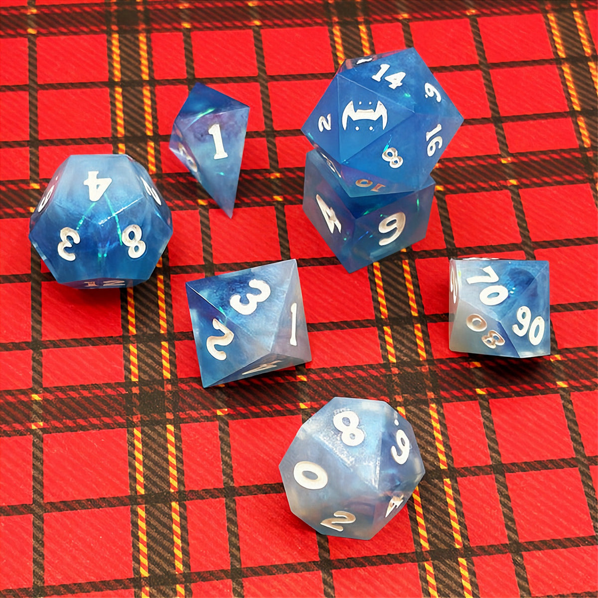Set of icy blue dice with star patterns on a dark background