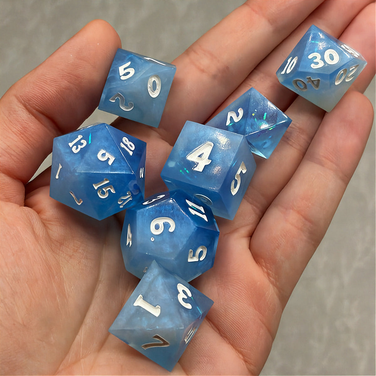 Set of icy blue dice with star patterns on a dark background