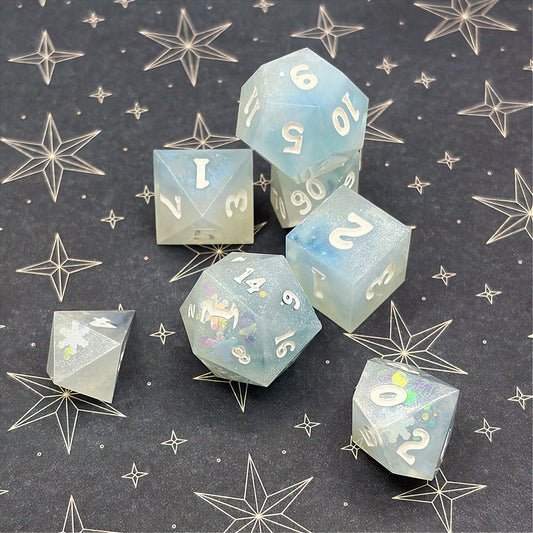 Set of light blue polyhedral dice on a dark background with star patterns