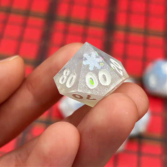 Set of light blue polyhedral dice on a dark background with star patterns