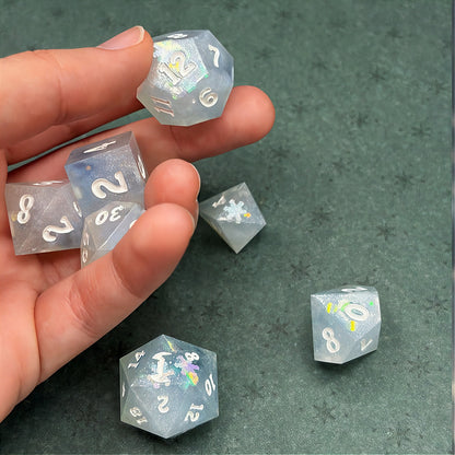 Set of light blue polyhedral dice on a dark background with star patterns