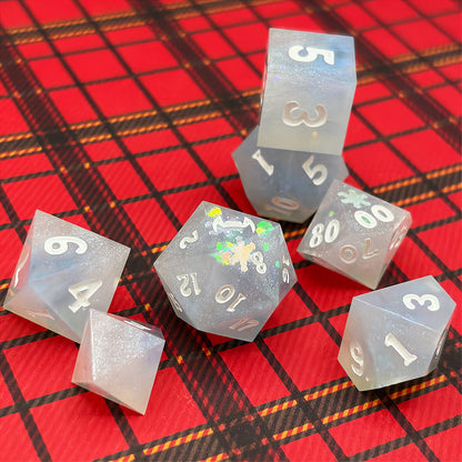 Set of light blue polyhedral dice on a dark background with star patterns