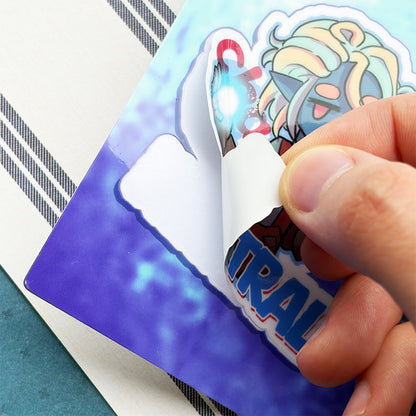 Hand peeling a colorful sticker off a blue card with 'URGE' branding.