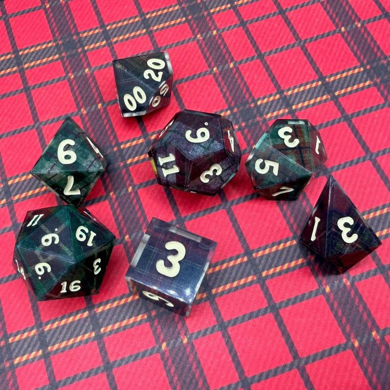 Set of polyhedral dice on a red and black checkered background