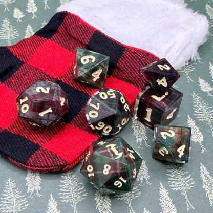 Set of polyhedral dice with red and black plaid fabric and white fur background