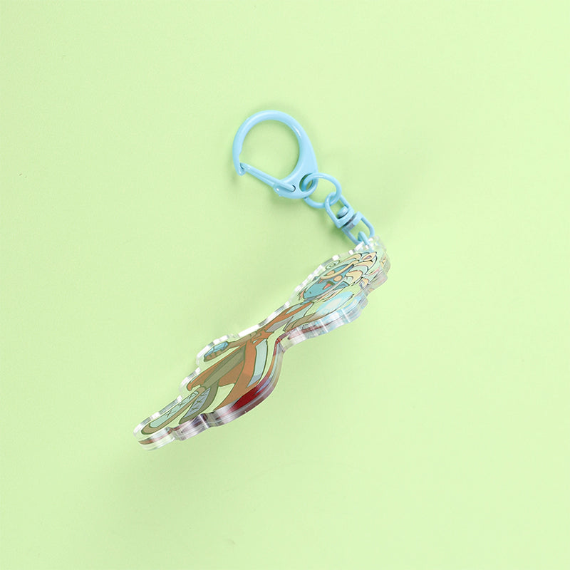 Decorative keychain with a blue clip on a light green background