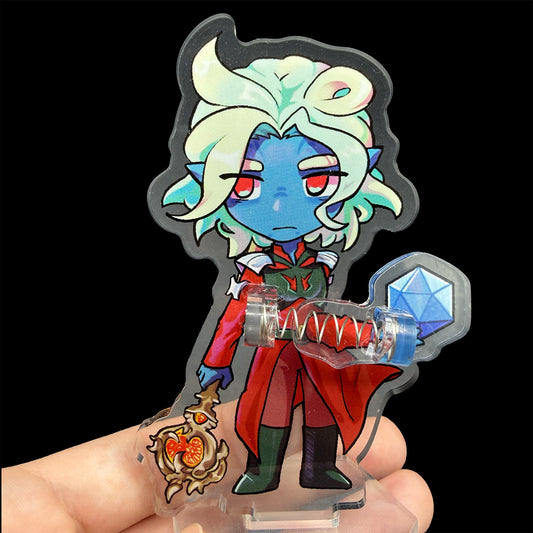 Colorful character figurine with a dice and staff on a reflective surface