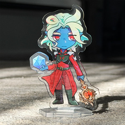 Colorful character figurine with a dice and staff on a reflective surface